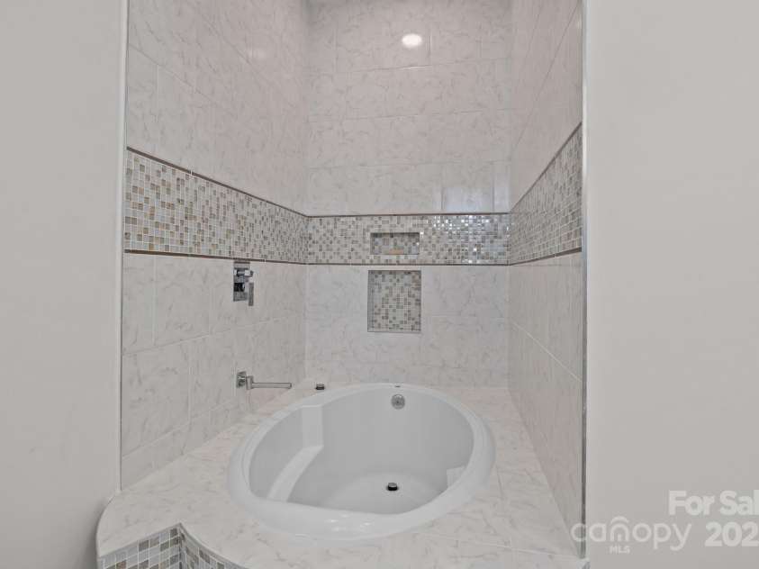 2117 Middlebridge Court, Fort Mill, SC 29715.  MLS# CAR4270419, YatesRealty ID 20149. Main level full bath. Built in garden tub with overhead shower