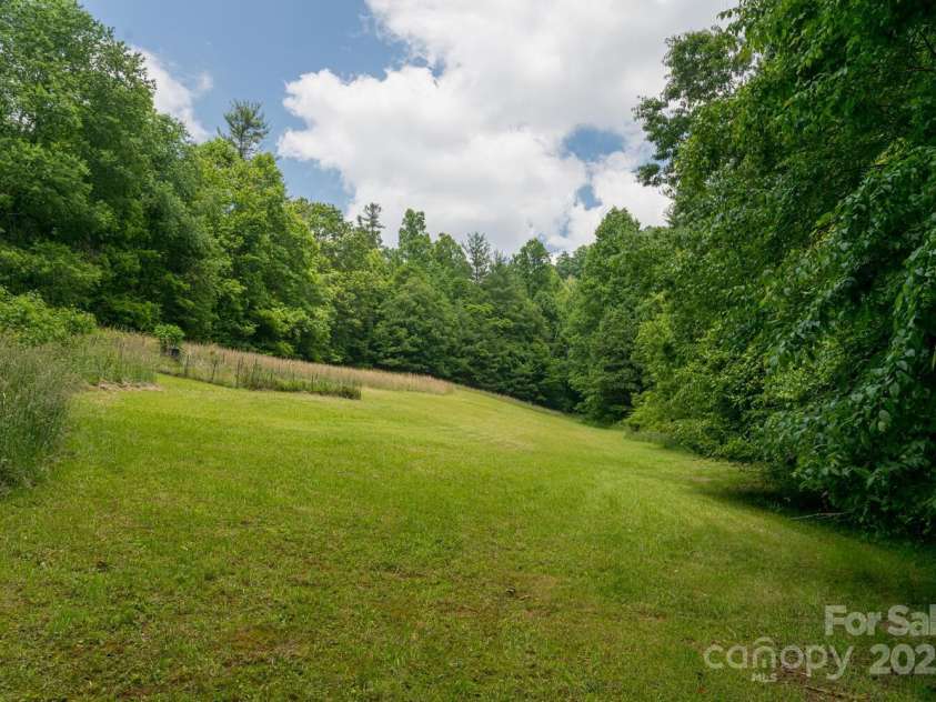 546 Scronce Creek Road, Burnsville, NC 28714.  MLS# CAR4243837, YatesRealty ID 20153. Large garden and field area.