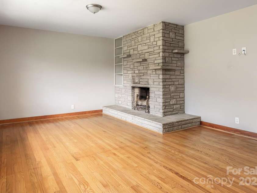 546 Scronce Creek Road, Burnsville, NC 28714.  MLS# CAR4243837, YatesRealty ID 20153. Living Room with Wood Burning Fireplace
