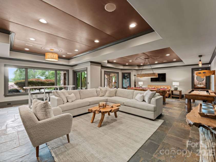172 Tennessee Circle, Mooresville, NC 28117.  MLS# CAR4252701, YatesRealty ID 20154. Lower-Level Living Roomis an open lounge space with TVs, billiards, and arcade games.