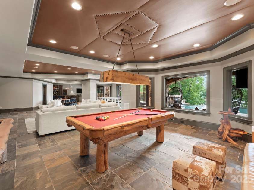 172 Tennessee Circle, Mooresville, NC 28117.  MLS# CAR4252701, YatesRealty ID 20154. Lower-Level Living Roomis an open lounge space with TVs, billiards, and arcade games.