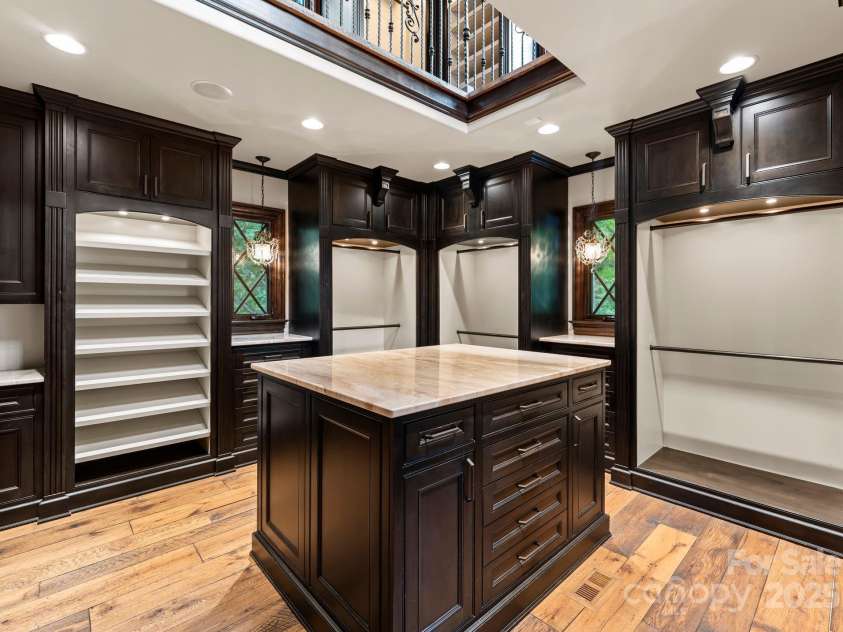 172 Tennessee Circle, Mooresville, NC 28117.  MLS# CAR4252701, YatesRealty ID 20154. Two-story boutique closet with light-filled luxury storage.