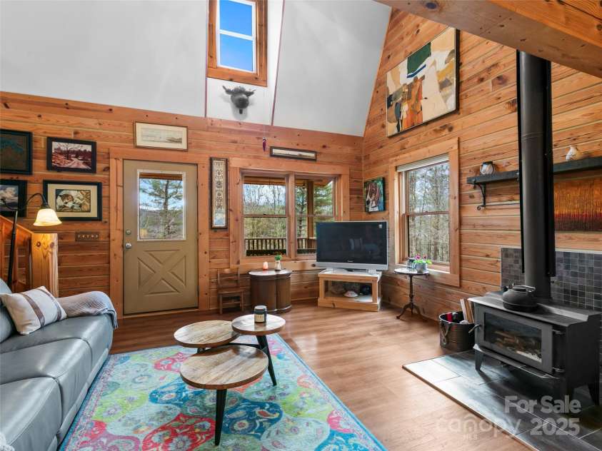 1239 Lower Loop Drive, Fletcher, NC 28732.  MLS# CAR4327631, YatesRealty ID 2016. Living Room with woodburning stove