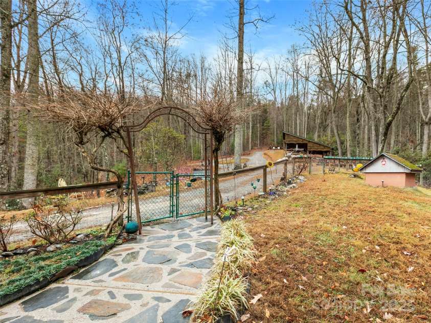 1239 Lower Loop Drive, Fletcher, NC 28732.  MLS# CAR4327631, YatesRealty ID 2016. Stone walkway to the house