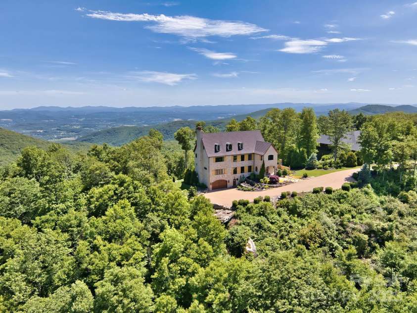 278 Snow Ridge Drive, Hendersonville, NC 28792.  MLS# CAR4221130, YatesRealty ID 20164. A picturesque landscape with breathtaking views surround this beautiful home with European aesthetic at 3,800ft on Bearwallow Mountain in the Grand Highlands gated community.