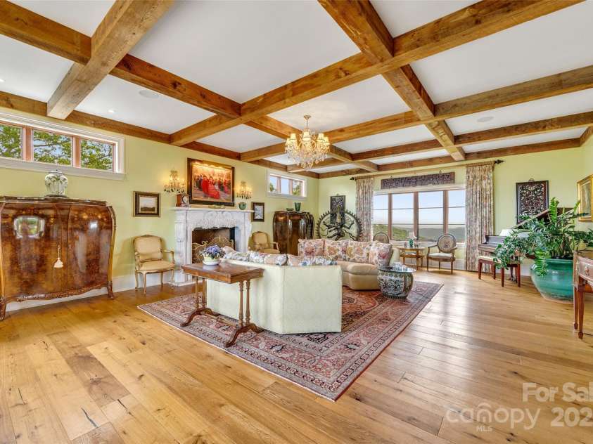 278 Snow Ridge Drive, Hendersonville, NC 28792.  MLS# CAR4221130, YatesRealty ID 20164. Antique chandeliers hang in the barrel vaulted gallery leading to an expansive 640sqft living room on the main level with N and S views.