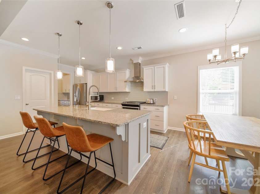 2035 Beacon Avenue, Monroe, NC 28110.  MLS# CAR4265036, YatesRealty ID 20173. Open kitchen with upgraded backsplash and vented hood