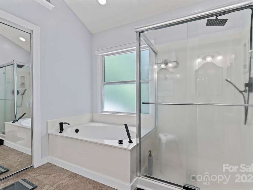 107 Glenmont Court, Mooresville, NC 28117.  MLS# CAR4267304, YatesRealty ID 20176. Separate tub and shower in primary suite bathroom