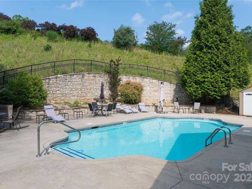 55 Outlook Circle, Swannanoa, NC 28778.  MLS# CAR4267011, YatesRealty ID 20219. Gated clubhouse pool featuring a grill and lounge chairs for relaxation.