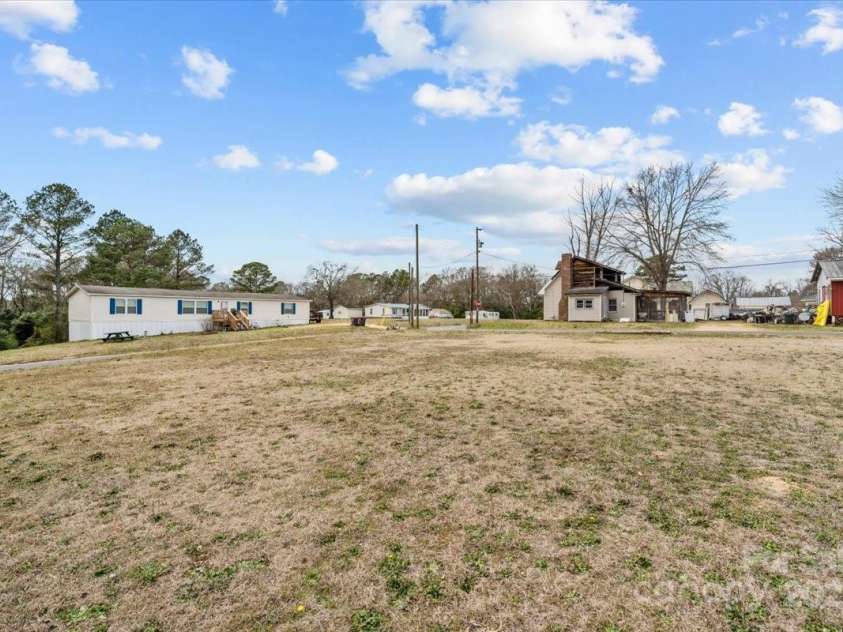 100 Lear Street, Rockingham, NC 28379.  MLS# CAR4223540, YatesRealty ID 2022. The vacant border parcel provides ample privacy.