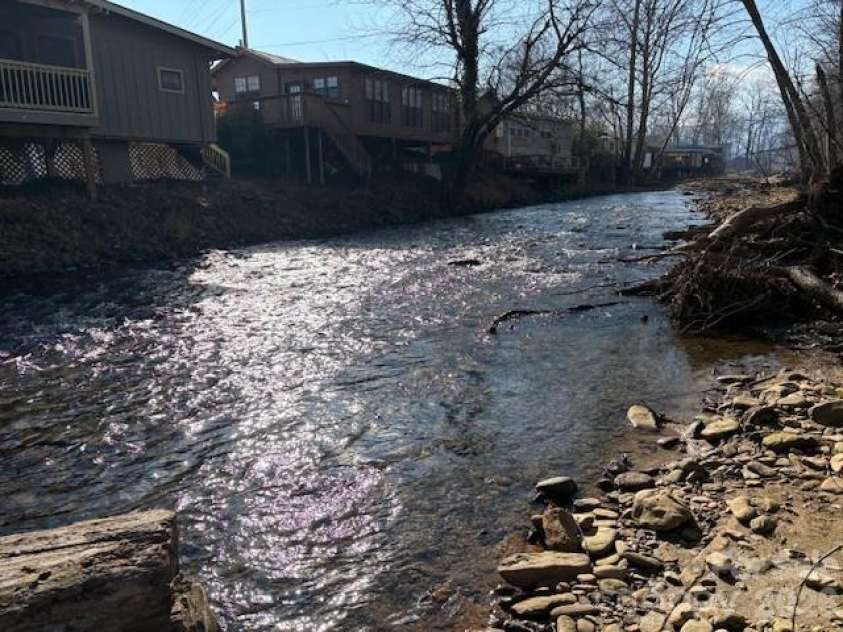 129 Mallard Loop, Waynesville, NC 28785.  MLS# CAR4335027, YatesRealty ID 2023. Back side of home as seen from across the creek