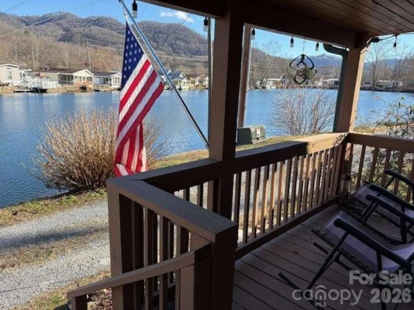 129 Mallard Loop, Waynesville, NC 28785.  MLS# CAR4335027, YatesRealty ID 2023. Front porch overlooks lake