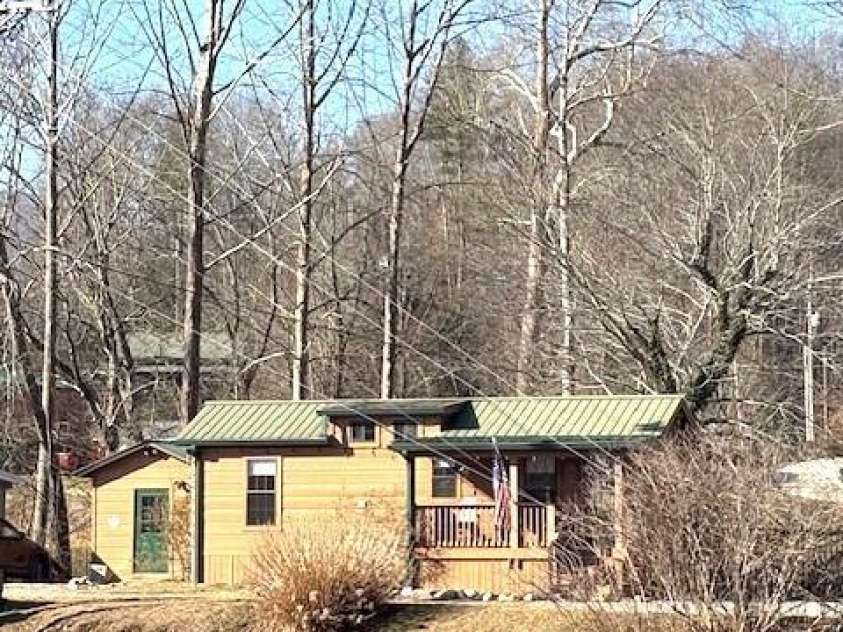 129 Mallard Loop, Waynesville, NC 28785.  MLS# CAR4335027, YatesRealty ID 2023. Home as seen from across the lake