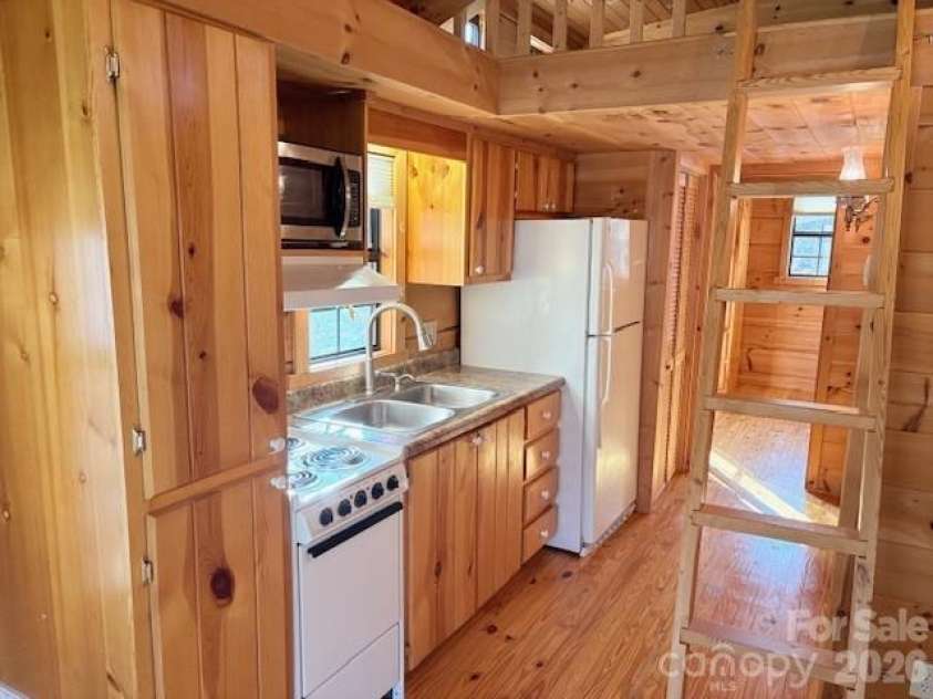 129 Mallard Loop, Waynesville, NC 28785.  MLS# CAR4335027, YatesRealty ID 2023. Kitchen & ladder to loft