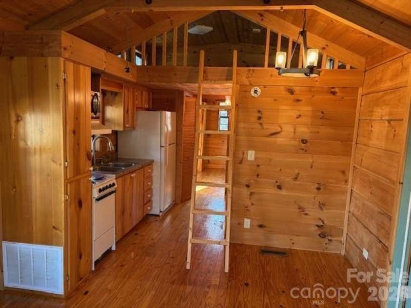 129 Mallard Loop, Waynesville, NC 28785.  MLS# CAR4335027, YatesRealty ID 2023. Other side of family room & dining area