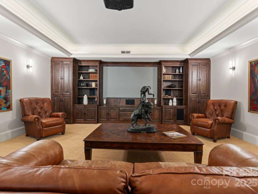 200 Highland Forest Drive, Charlotte, NC 28270.  MLS# CAR4242053, YatesRealty ID 20236. Basement level entertainment theater with a 100-inch infinity screen projector system and built-in custom cabinetry.