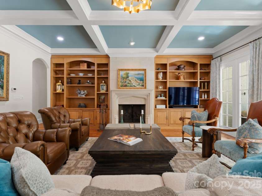 200 Highland Forest Drive, Charlotte, NC 28270.  MLS# CAR4242053, YatesRealty ID 20236. Family room with custom built-in shelving and cabinetry. Offers access to outdoor patio.