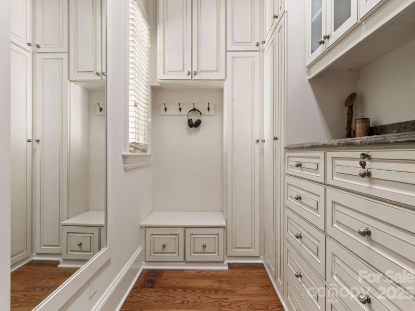 200 Highland Forest Drive, Charlotte, NC 28270.  MLS# CAR4242053, YatesRealty ID 20236. Private dressing room with marble countertop, glass front cabinets, built-in ironing board, locking jewelrydrawer, and an electronic wall safe in primary closet.
