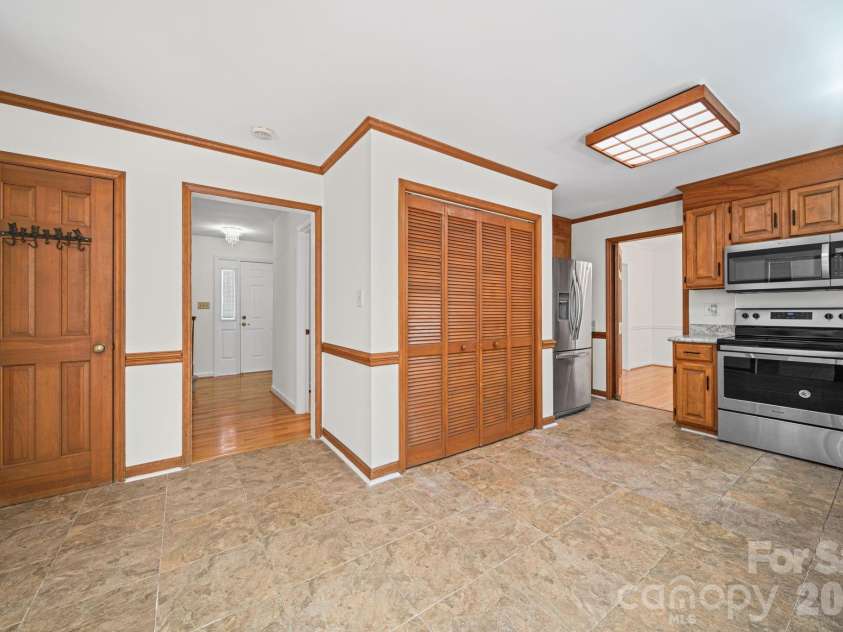 6520 Dougherty Drive, Charlotte, NC 28213.  MLS# CAR4377449, YatesRealty ID 20248. Another view of kitchen (washer/dryer behind lever doors)