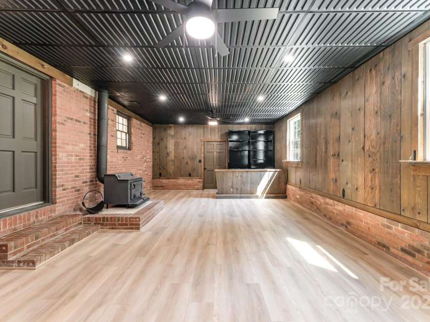9410 Mountain Aire Circle, Charlotte, NC 28214.  MLS# CAR4271778, YatesRealty ID 20251. Rec room has so much room for entertaining or just cozy by the wood burning stove.