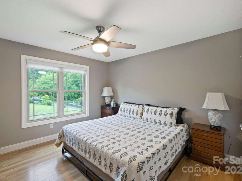 288 Ollie Weaver Road, Weaverville, NC 28787.  MLS# CAR4269198, YatesRealty ID 20259. Bedroom w/walk-in closet overlooks the yard