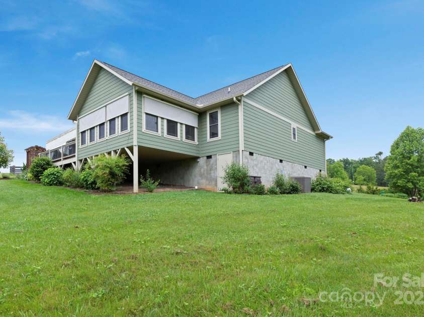 288 Ollie Weaver Road, Weaverville, NC 28787.  MLS# CAR4269198, YatesRealty ID 20259. Behind the house in corner of lot