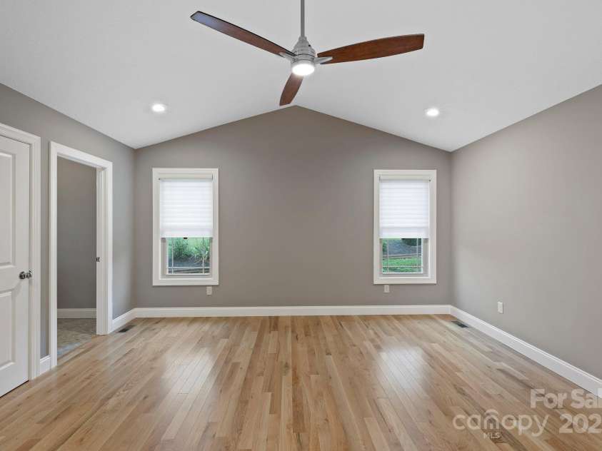 288 Ollie Weaver Road, Weaverville, NC 28787.  MLS# CAR4269198, YatesRealty ID 20259. Primary bedroom w/oak floor/recessed lighting