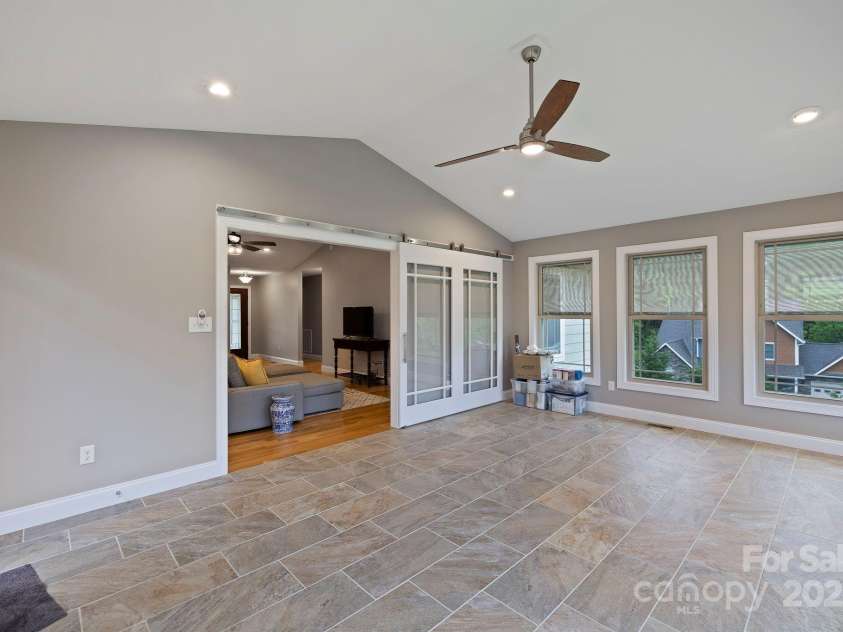 288 Ollie Weaver Road, Weaverville, NC 28787.  MLS# CAR4269198, YatesRealty ID 20259. Sunroom allows for overflow of guests