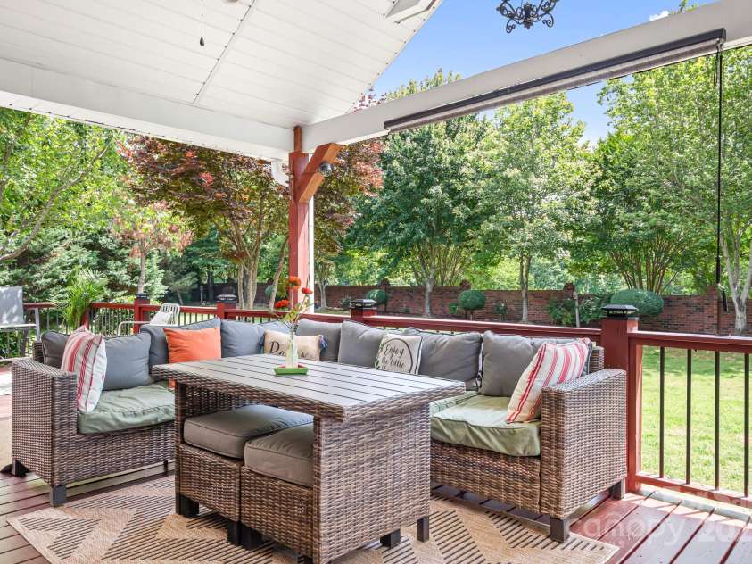 9112 Butterfly Court, Gastonia, NC 28056.  MLS# CAR4267047, YatesRealty ID 20271. Covered Back Porch is where it all happens.  Double in size and overlooking the wide back yard with beautiful landscaping that offers privacy and views.