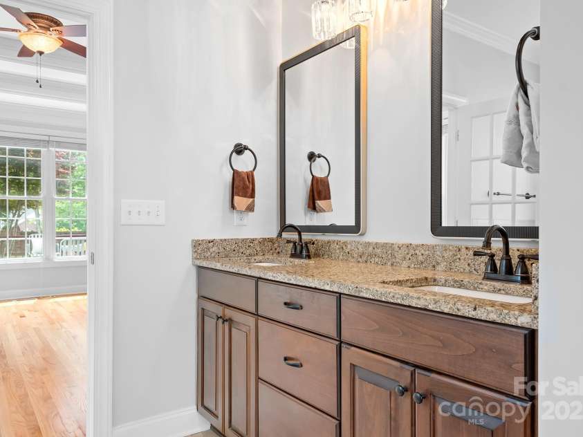 9112 Butterfly Court, Gastonia, NC 28056.  MLS# CAR4267047, YatesRealty ID 20271. Primary Bath with  BRAND NEW paint, Diamond Fusion, Enduroshield & Invisashield ShowerGuard Glass Shower enclosure, Mirrors, and lighting.