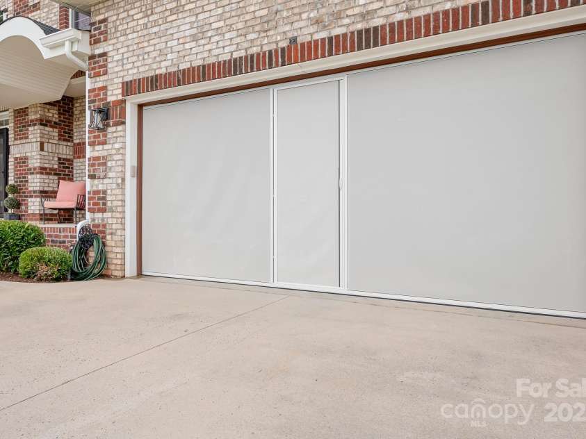 9112 Butterfly Court, Gastonia, NC 28056.  MLS# CAR4267047, YatesRealty ID 20271. Pull down screen door turns the potential for garage into yet another gathering room or just to create a beautiful cross breeze inside the home.
