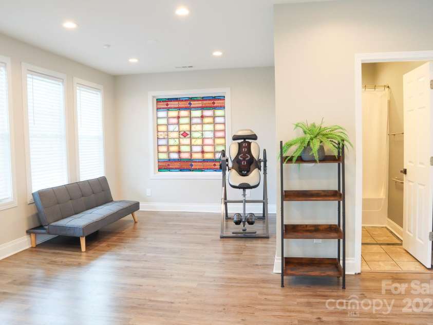 7768 Pinecone Lane, Hickory, NC 28602.  MLS# CAR4257441, YatesRealty ID 20276. Basement Family Room with stained glass window