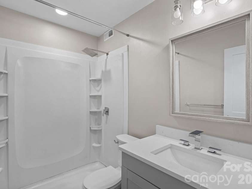 3021 Heathstead Place, Charlotte, NC 28210.  MLS# CAR4358212, YatesRealty ID 20285. Primary bath with updated shower, recessed lighting and updated vanity