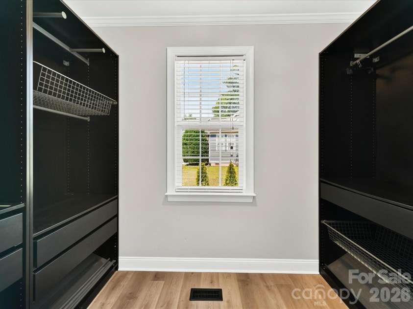 6603 Havencrest Drive, Denver, NC 28037.  MLS# CAR4400995, YatesRealty ID 20296. The spacious walk in primary closet features custom built in organization systems, abundant storage, and a window that fills the space with natural light.