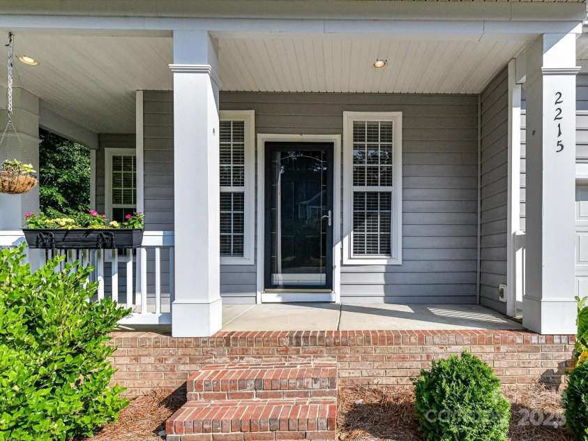 2215 Henery Tuckers Court, Charlotte, NC 28270.  MLS# CAR4267429, YatesRealty ID 20299. A wrap-around covered front porch greets you!