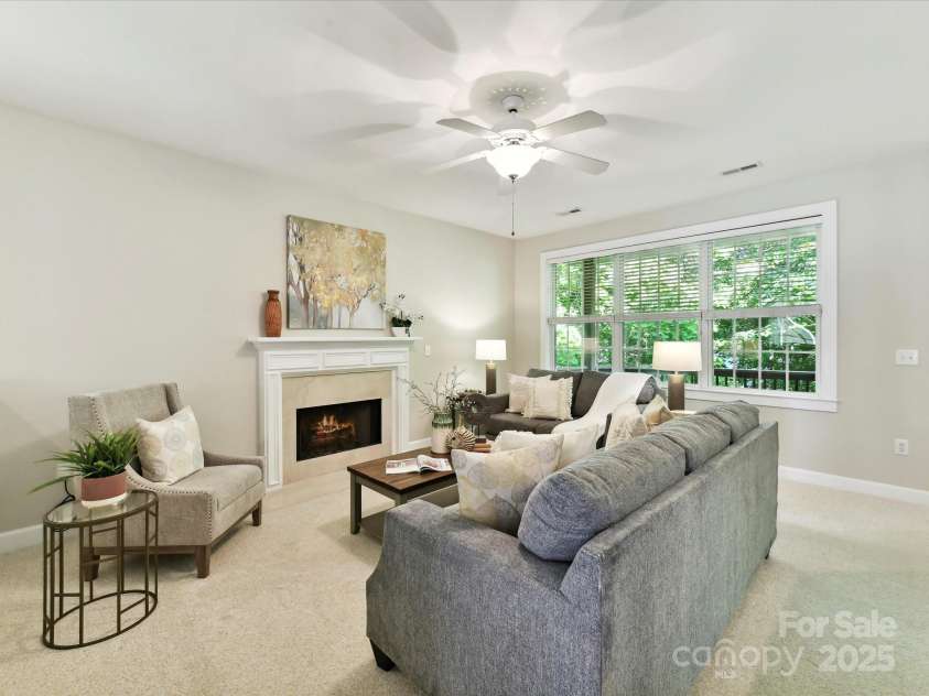 2215 Henery Tuckers Court, Charlotte, NC 28270.  MLS# CAR4267429, YatesRealty ID 20299. Main level den features a gas fireplace