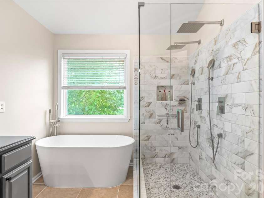 13934 Kings Carriage Lane, Charlotte, NC 28278.  MLS# CAR4424593, YatesRealty ID 20305. Oversized shower with two rainfall heads with beautiful tile surround