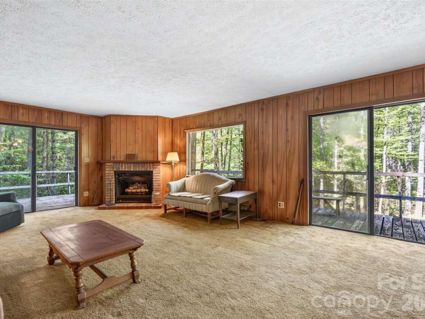 451 Signal Tree Road, Deep Gap, NC 28618.  MLS# CAR4374563, YatesRealty ID 20306. Den with two sliding glass doors providing access to the wraparound deck. 
