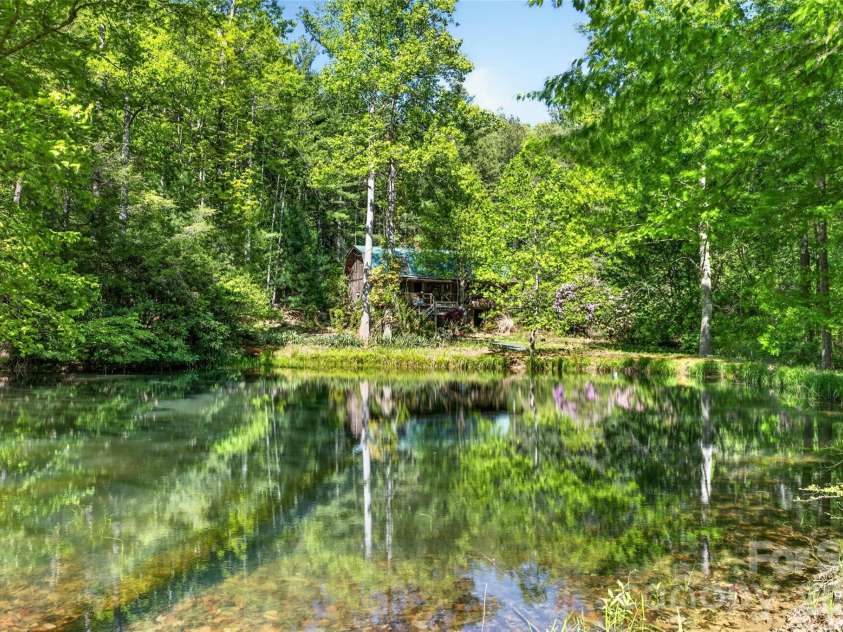 451 Signal Tree Road, Deep Gap, NC 28618.  MLS# CAR4374563, YatesRealty ID 20306. View across the spring-fed pond towards the secondary cabin. 