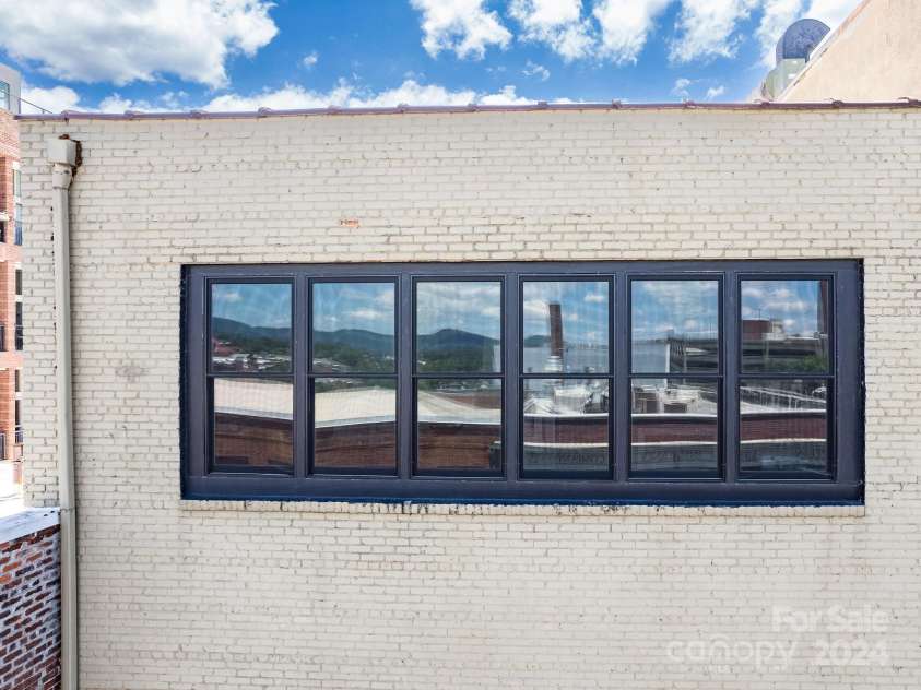 53-C College Street, Asheville, NC 28801.  MLS# CAR4162571, YatesRealty ID 2031. Picture windows in main living area