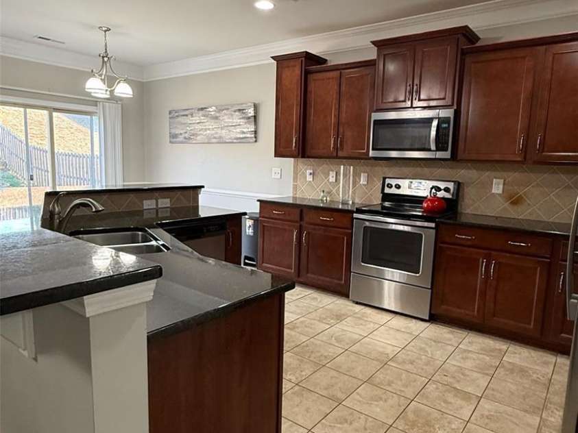 7910 Sweet Grove Court, Charlotte, NC 28269.  MLS# CAR4331516, YatesRealty ID 20319. Modern Kitchen with Cherry Cabinets