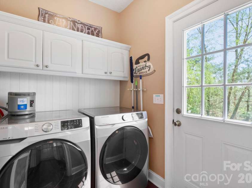 10 Eagle Drive, Hendersonville, NC 28792.  MLS# CAR4365502, YatesRealty ID 20321. Laundry room with door to the deck/backyard