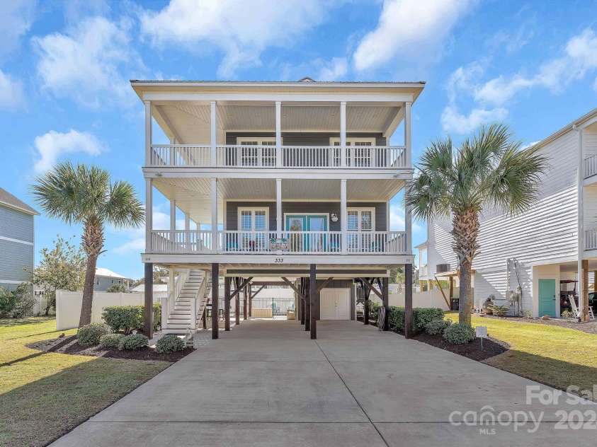 333 Calhoun Drive, Garden City, SC 29576.  MLS# CAR4176788, YatesRealty ID 2033. Golf cart storage room underneath home.