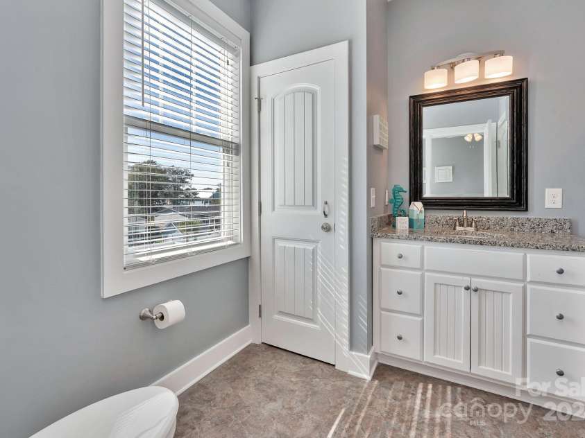 333 Calhoun Drive, Garden City, SC 29576.  MLS# CAR4176788, YatesRealty ID 2033. Owners closet in bathroom. Linen closet for guests behind door to bathroom