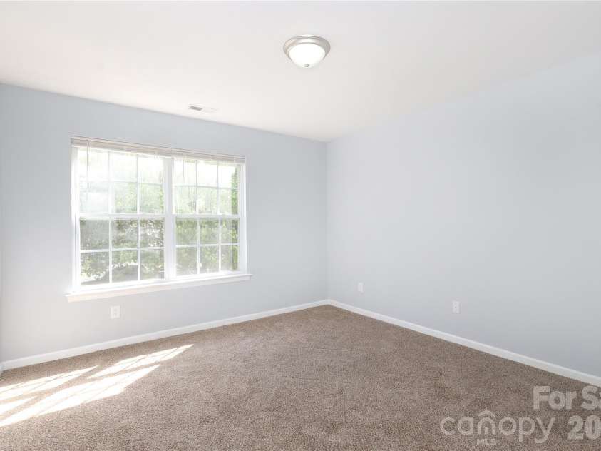 10910 Elm Bend Drive, Charlotte, NC 28273.  MLS# CAR4337592, YatesRealty ID 20339. Bedroom 2 with double window front. New paint and carpet.