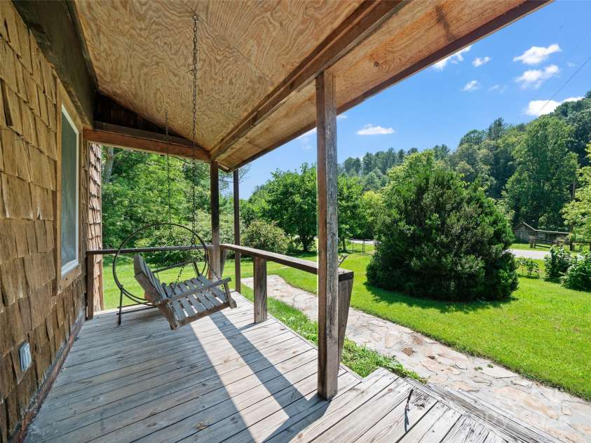 9065 NC 63 Highway, Leicester, NC 28748.  MLS# CAR4286038, YatesRealty ID 2034. Front Porch Waiting for Sweet Tea