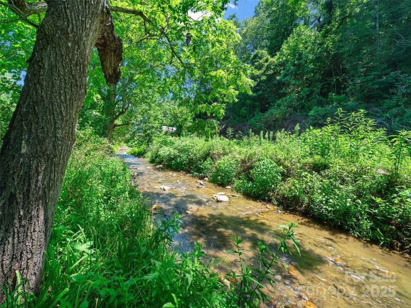 9065 NC 63 Highway, Leicester, NC 28748.  MLS# CAR4286038, YatesRealty ID 2034. Little Sandy Mush Creek Frontage