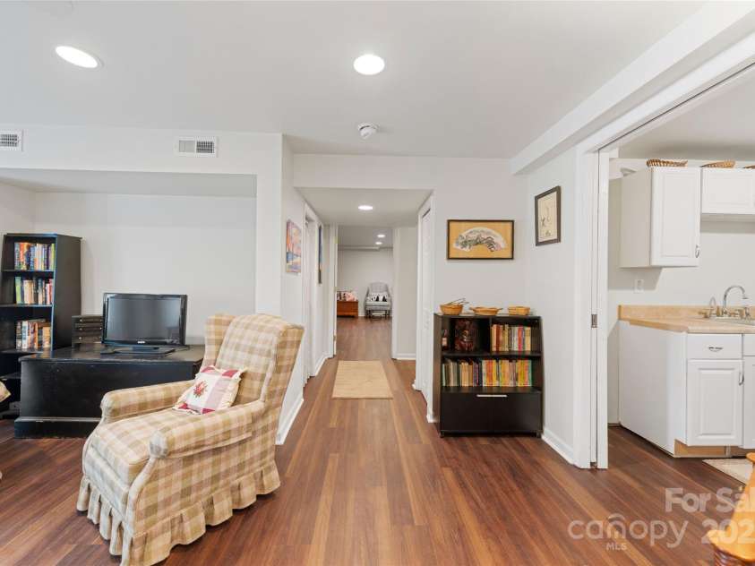 261 Forest Hill Drive, Asheville, NC 28803.  MLS# CAR4269408, YatesRealty ID 20353. Lower level app: Living room to the left, kitchen to the right and laundry and hall to huge bedroom and bathroom