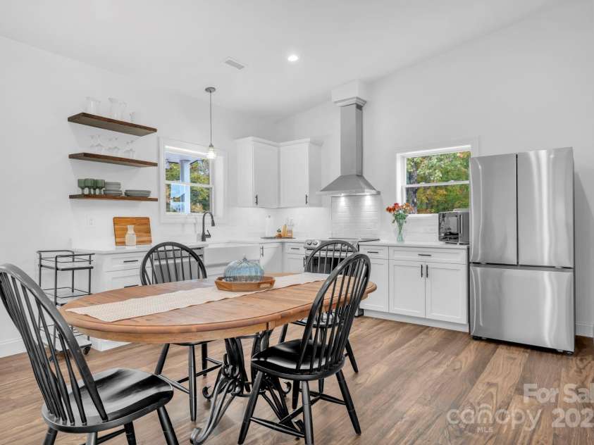 1260 Beaver Island Trail Road, Walnut Cove, NC 27052.  MLS# CAR4325171, YatesRealty ID 2036. Guest house kitchen w/ Samsung appliances, 3 decorative floating shelves, and open floor plan to living room