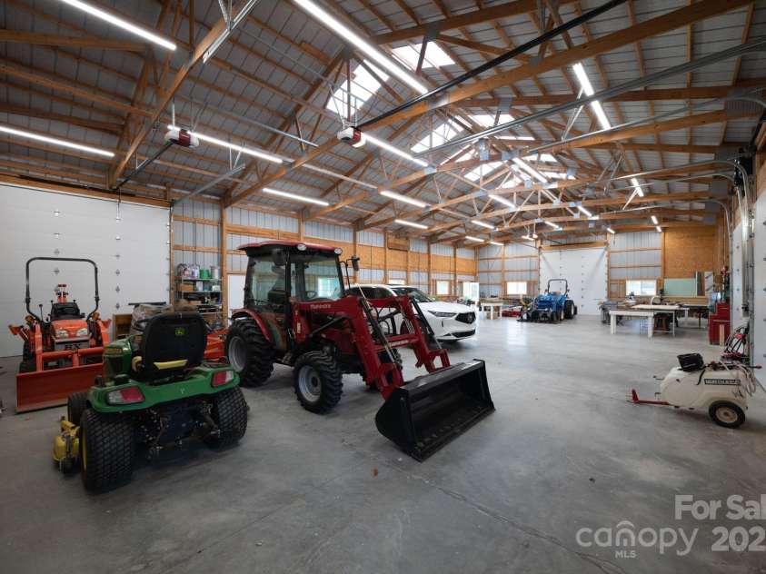 1260 Beaver Island Trail Road, Walnut Cove, NC 27052.  MLS# CAR4325171, YatesRealty ID 2036. Interior of equipment building, 2 door entrances, and 4 motorized garage doors